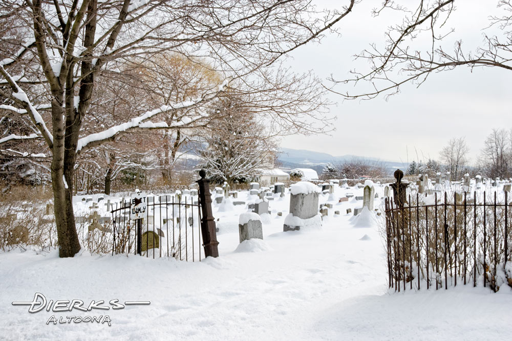 Peaceful cemetery in winter snow and sunlight.