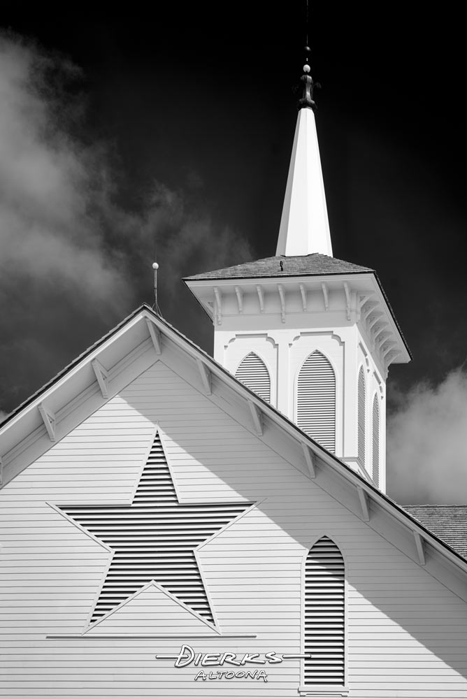 The Star Barn steeple and star in a back and white close-up, classic Gothic Revival architecture.